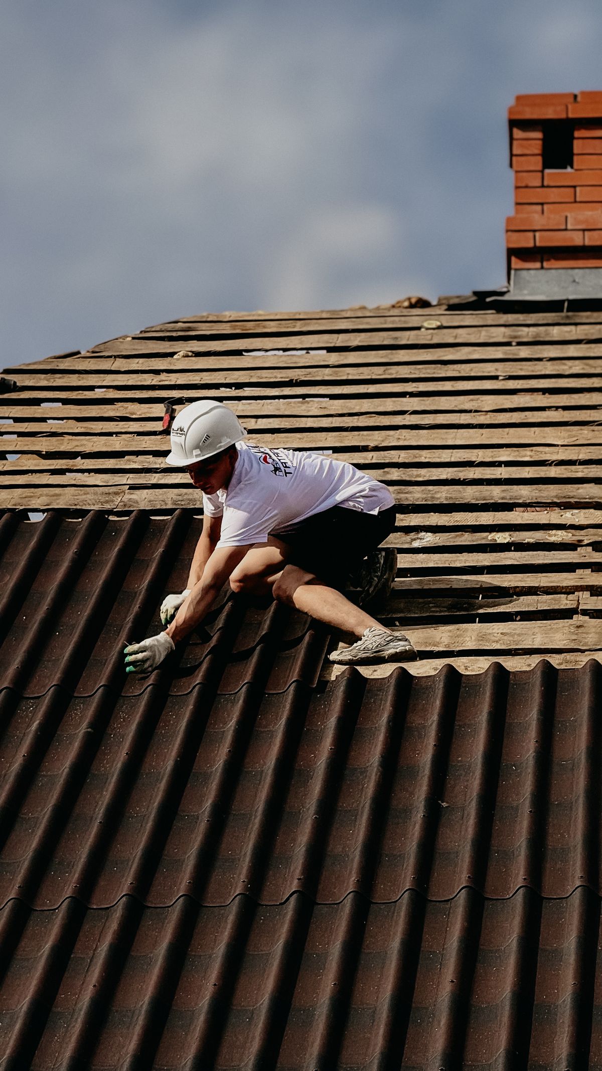 Roofer fitting tiles on a pitched roof